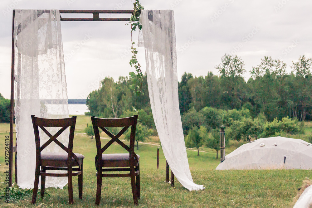A natural wedding with a lake view. Rustic wedding decoration. Boho scenery. A natural wedding with a lake view. Rustic wedding decoration. Boho scenery.