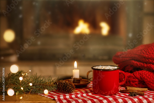 mug of cocoa with marshmallows near the fireplace at Christmas photo