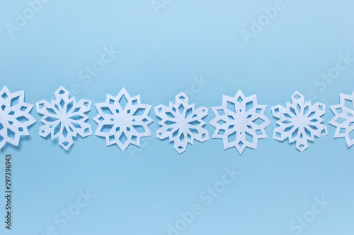 Line arrangement of snowflakes on blue backgound