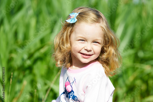 Cute blond girl smiling at the camera