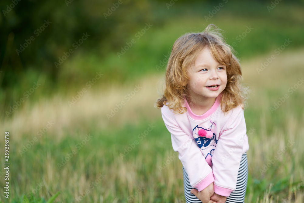 Little blond girl posing in the field Little blond girl posing in the field