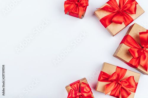 Frame of cardboard gift boxes with red bows.