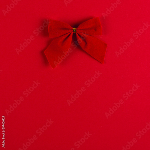 Bow on a red background, Christmas concept, copy space.