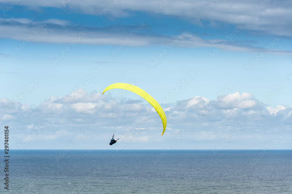 A paraglider flies over the Atlantic Ocean off the coast of the Basque Country (Spain). A paraglider flies over the Atlantic Ocean off the coast of the Basque Country (Spain).