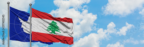 Antarctica and Lebanon flag waving in the wind against white cloudy blue sky together. Diplomacy concept, international relations.