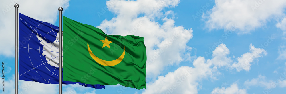Antarctica and Mauritania flag waving in the wind against white cloudy blue sky together. Diplomacy concept, international relations. Antarctica and Mauritania flag waving in the wind against white cloudy blue sky together. Diplomacy concept, international relations.