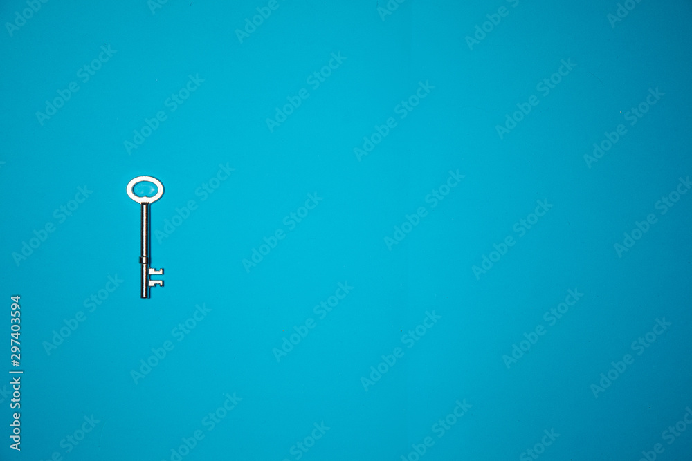 Key on blue background. Minimal creative style Key on blue background. Minimal creative style