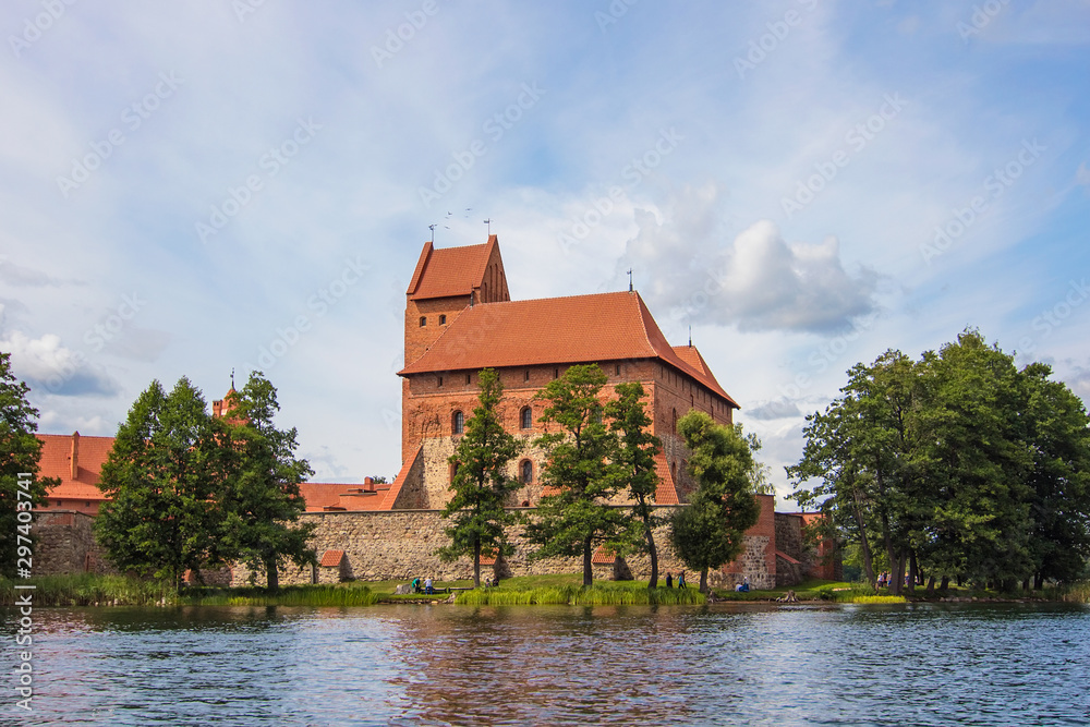 Yachts and medieval gothic Trakai Island Castle with stone walls and towers with red tiled roofs in lake Galve, Lithuania. Trakai Castle is one of major tourist attractions of Lithuania Yachts and medieval gothic Trakai Island Castle with stone walls and towers with red tiled roofs in lake Galve, Lithuania. Trakai Castle is one of major tourist attractions of Lithuania