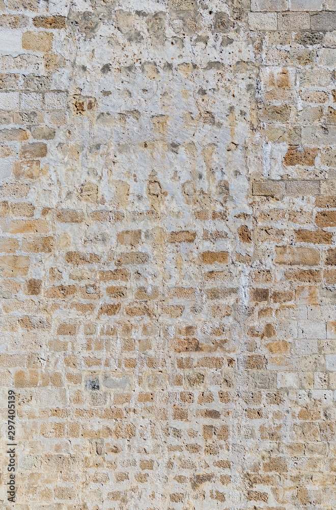 Old and aged brick wall with some weathered plastering. High resolution full frame textured background.