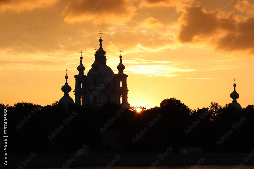 orange sunset with dark church on the horizon