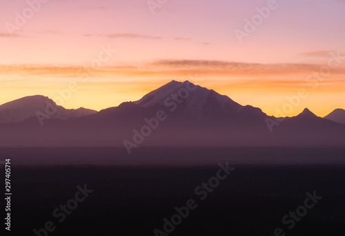Dramatic light with silhouette of mountains during sunrise