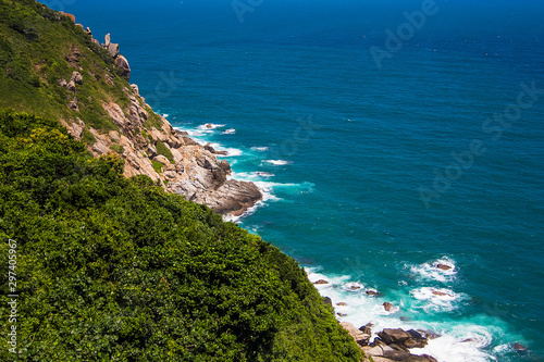Beautiful rocks on the small Boundary island near Sanya, Hainan island, blue South China sea, China. Green trees and azure waves, top view
