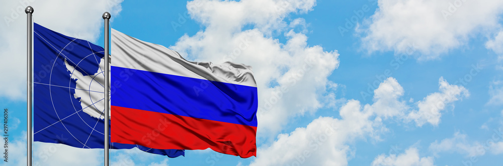 Antarctica and Russia flag waving in the wind against white cloudy blue sky together. Diplomacy concept, international relations. Antarctica and Russia flag waving in the wind against white cloudy blue sky together. Diplomacy concept, international relations.