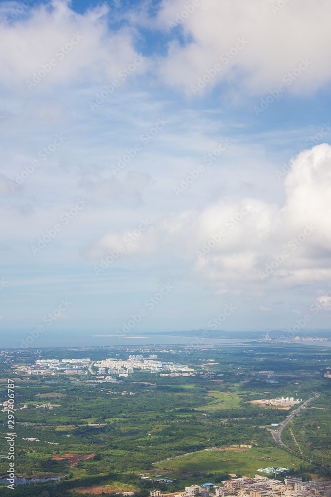 Aerial view on the beautiful exotic Hainan island, China. Clouds and fields seen from the airplane