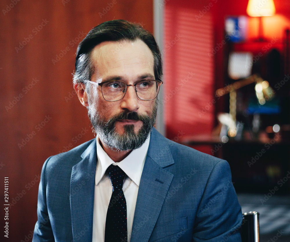 Portrait of attractive caucasian bearded aged guy at workplace Portrait of attractive caucasian bearded aged guy at workplace
