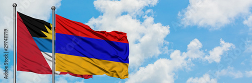 Antigua and Barbuda with Armenia flag waving in the wind against white cloudy blue sky together. Diplomacy concept, international relations.