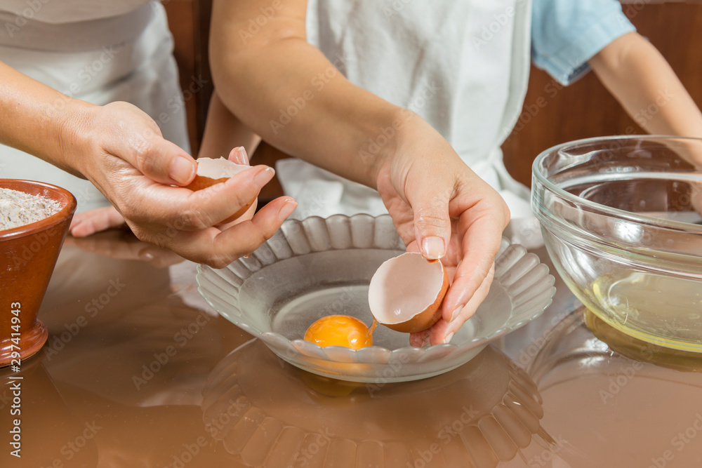 A woman and a child cooking together. A woman and a child cooking together.