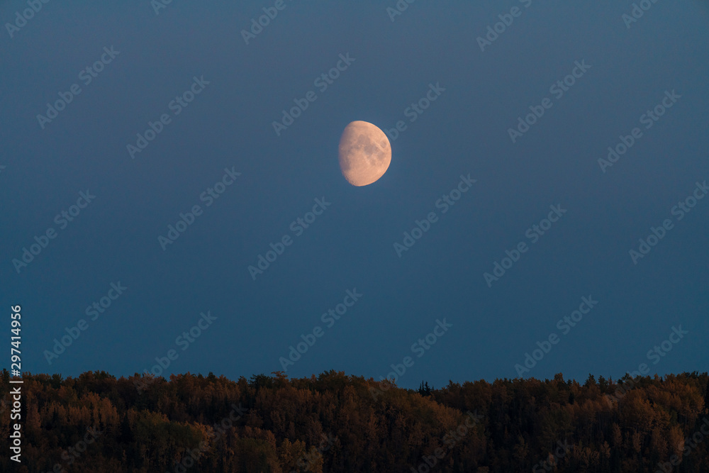 Alaskan mountains with half moon and pink skies after sunset during blue hour Alaskan mountains with half moon and pink skies after sunset during blue hour