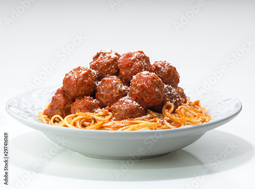 spaghetti  & meatballs with parmesan cheese on a plate