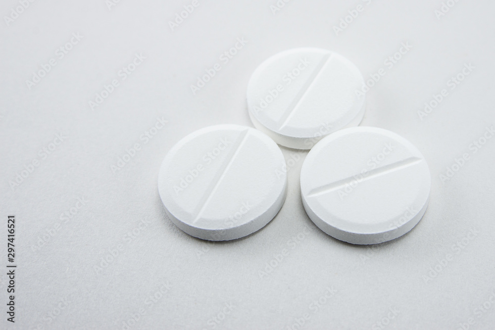 white round close-up pills macro isolated on white background white round close-up pills macro isolated on white background