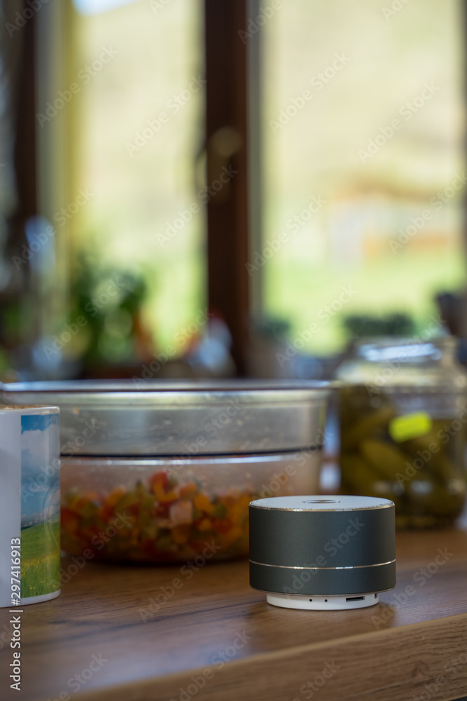 Smart ai speaker with woman cooking in the background. Smart home concept Smart ai speaker with woman cooking in the background. Smart home concept