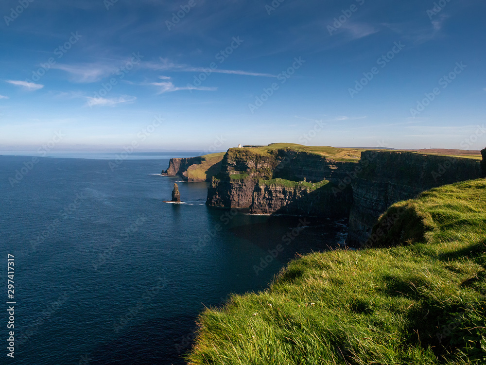 View from Cliff of Moher, county Clare, Ireland, Atlantic ocean, Sunny day, Bright blue cloudy sky. Popular Irish landmark.