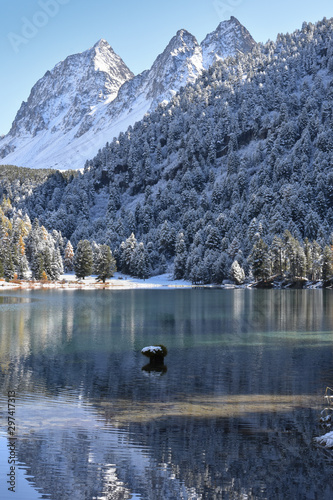 Beautiful view at the lake Palpuogna in Switzerland after snowing in October. Autumn meets winter in the alps in Switzerland. 