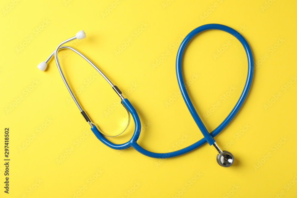 Stethoscope on yellow background, top view and space for text Stethoscope on yellow background, top view and space for text