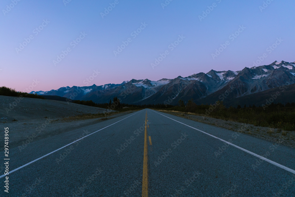 Fototapeta premium Scenic highway surrounded by mountains and trees in autumn season in Alaska