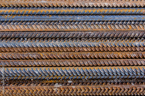 Construction rebar with traces of rust. Industrial background.