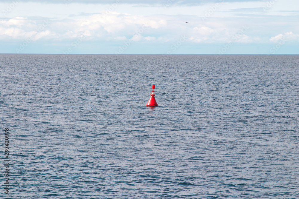 Image of a red sea buoy on the water