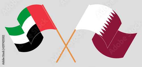 Crossed and waving flags of the United Arab Emirates and Qatar