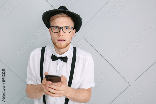 Worried young man with mobi...