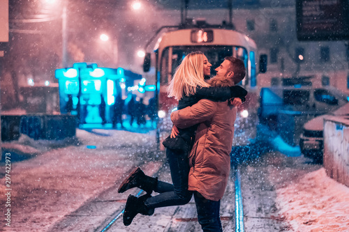 Young adult couple on the snow-covered tram line photo