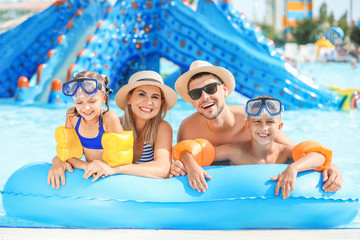 Happy family resting in aqua park