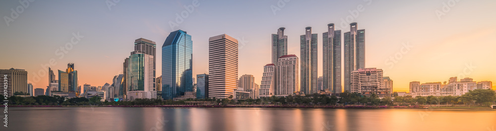 Skyscrapers Reflected in a Lake at Sunrise. Benjakiti Park in Bangkok, Thailand