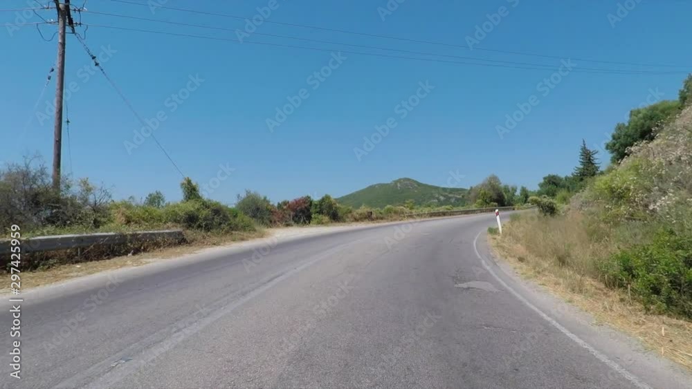 View of the road among the mountains on the island of Corfu, Greece. The camera is mounted on a car. View of the road among the mountains on the island of Corfu, Greece. The camera is mounted on a car.