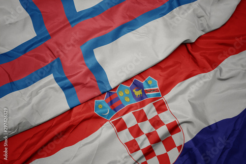 waving colorful flag of croatia and national flag of faroe islands.