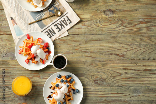 Wallpaper Mural Plates with tasty waffles, berries and ice cream on wooden table Torontodigital.ca
