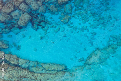Fototapeta Naklejka Na Ścianę i Meble -  An aerial view of the beautiful Mediterranean sea, where you can se the rocky textured underwater corals and the clean turquoise water of blue lagoon Agia Napa