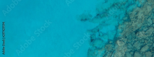 An aerial view of the beautiful Mediterranean sea, where you can se the rocky textured underwater corals and the clean turquoise water of blue lagoon Agia Napa