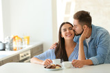 Happy young couple in kitchen at home