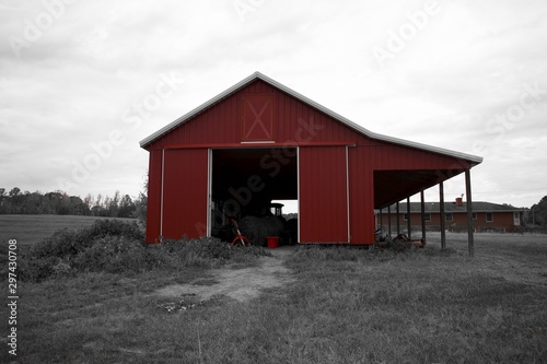 Red barn in black and white photo 