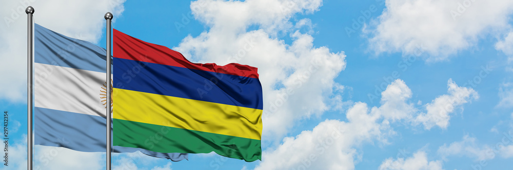 Obraz premium Argentina and Mauritius flag waving in the wind against white cloudy blue sky together. Diplomacy concept, international relations.