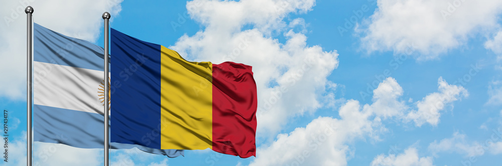 Argentina and Romania flag waving in the wind against white cloudy blue sky together. Diplomacy concept, international relations. Argentina and Romania flag waving in the wind against white cloudy blue sky together. Diplomacy concept, international relations.