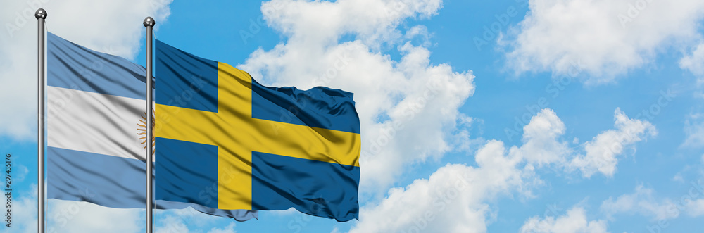 Argentina and Sweden flag waving in the wind against white cloudy blue sky together. Diplomacy concept, international relations. Argentina and Sweden flag waving in the wind against white cloudy blue sky together. Diplomacy concept, international relations.