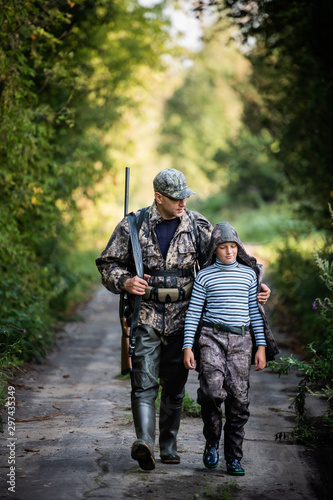 father pointing and guiding son on first deer hunt