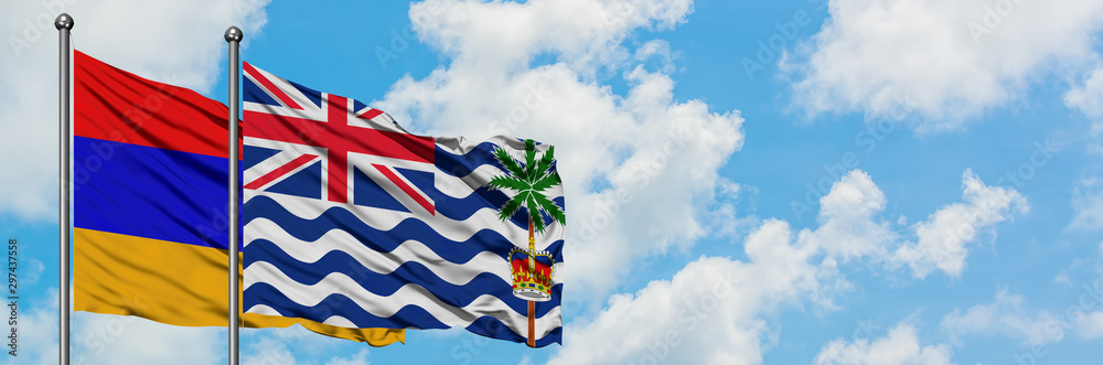 Armenia and British Indian Ocean Territory flag waving in the wind against white cloudy blue sky together. Diplomacy concept, international relations. Armenia and British Indian Ocean Territory flag waving in the wind against white cloudy blue sky together. Diplomacy concept, international relations.