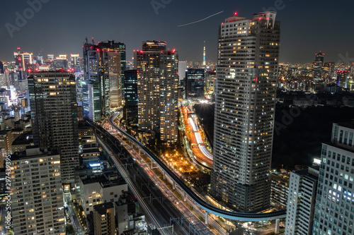 浜松町から見える高速道路、鉄道、モノレール、航空機の光跡とビル群の夜景 photo