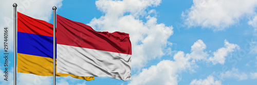 Armenia and Indonesia flag waving in the wind against white cloudy blue sky together. Diplomacy concept, international relations.